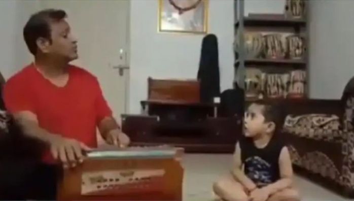 Little boy singing classical song with his father