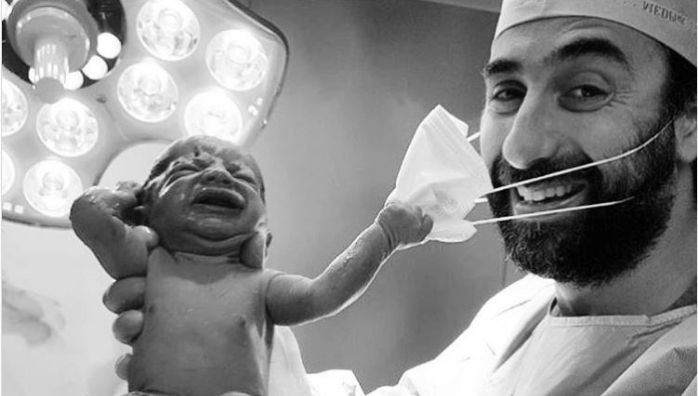 Viral Pic of baby removing doctors mask