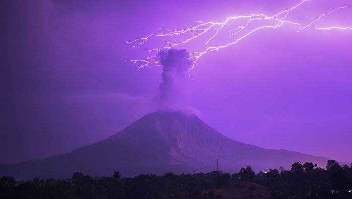 Sky changes colour as lightning bolt strikes above erupting Mount Sinabung volcano