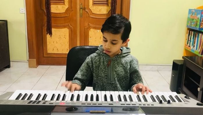 Little boy playing Rasputin song in Keyboard