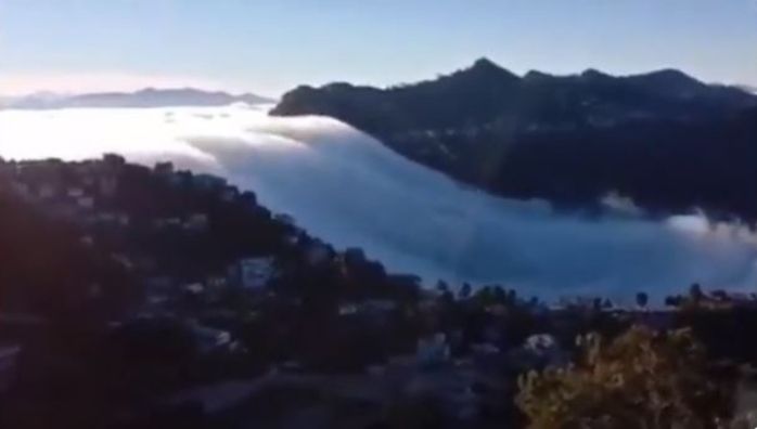Clouds cascade down the mountains